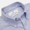 View 2 of product The Turnbull & Asser Blue Chambray Weekend Fit Shirt features a Dorset collar, 1-button cuffs, and white buttons, shown flat on a white background.
