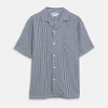 View 1 of product The Turnbull & Asser Navy & White Lyocell Stripe Holiday Fit Shirt is a short-sleeve button-up with a revere collar, vertical navy and white stripes, and a left chest pocket.