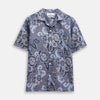 View 1 of product The Blue & White Tapestry Weave Cotton Holiday Fit Shirt by Turnbull & Asser features short sleeves, a revere collar, and a button-up front with a blue and white patterned textured fabric, shown against a plain white background.