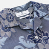 View 2 of product The Blue & White Tapestry Weave Cotton Holiday Fit Shirt by Turnbull & Asser features short sleeves, a revere collar, and a button-up front with a blue and white patterned textured fabric, shown against a plain white background.