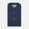 View 1 of product The Turnbull & Asser Holiday Fit Stripe Linen Short Sleeve Shirt features a navy background with vertical white stripes, a revere collar, and white buttons.