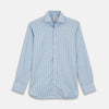 View 1 of product The Turnbull & Asser Tailored Fit Light Blue Gingham Shirt features a Kent collar, 2-button cuffs, and a small blue-and-white checkered pattern, shown on a white background.