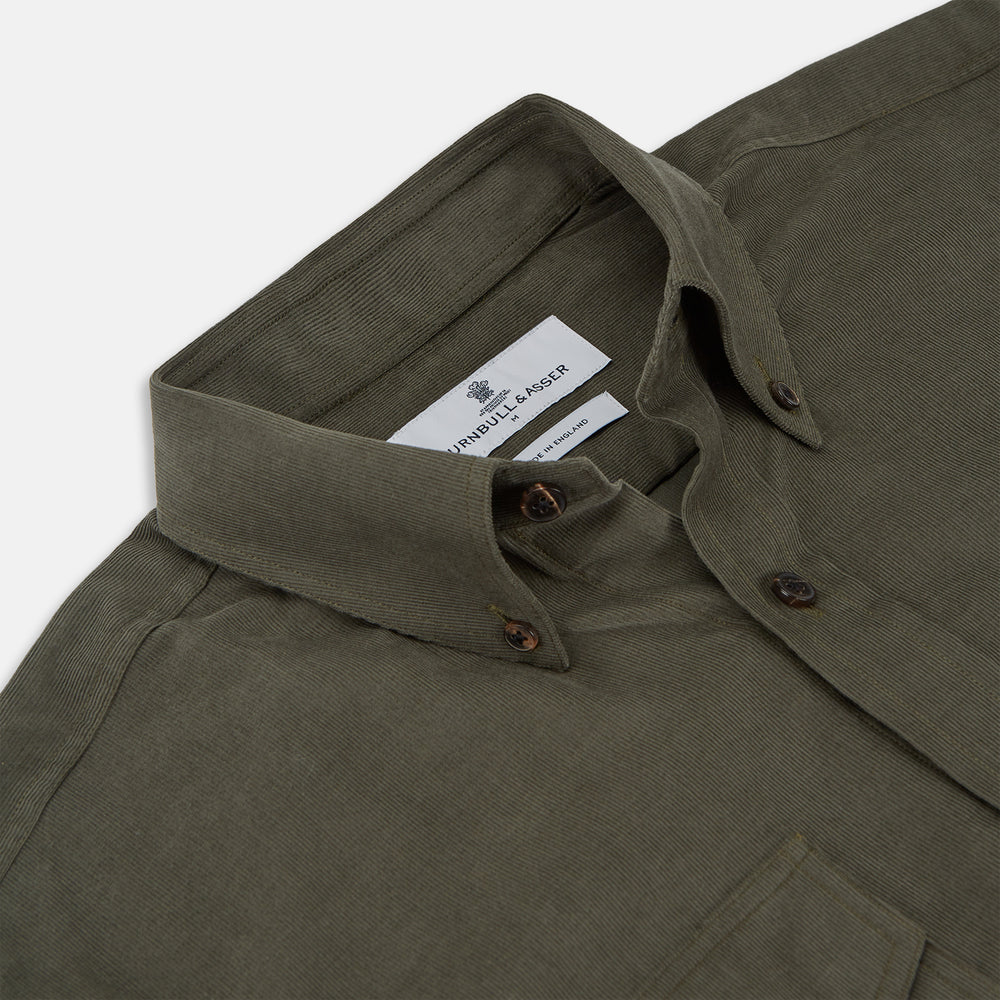 The Turnbull & Asser Khaki Corduroy Officer Weekend Fit Shirt features a Dorset collar, one-button cuffs, and two chest pockets with buttoned flaps, shown laid flat on a white background.