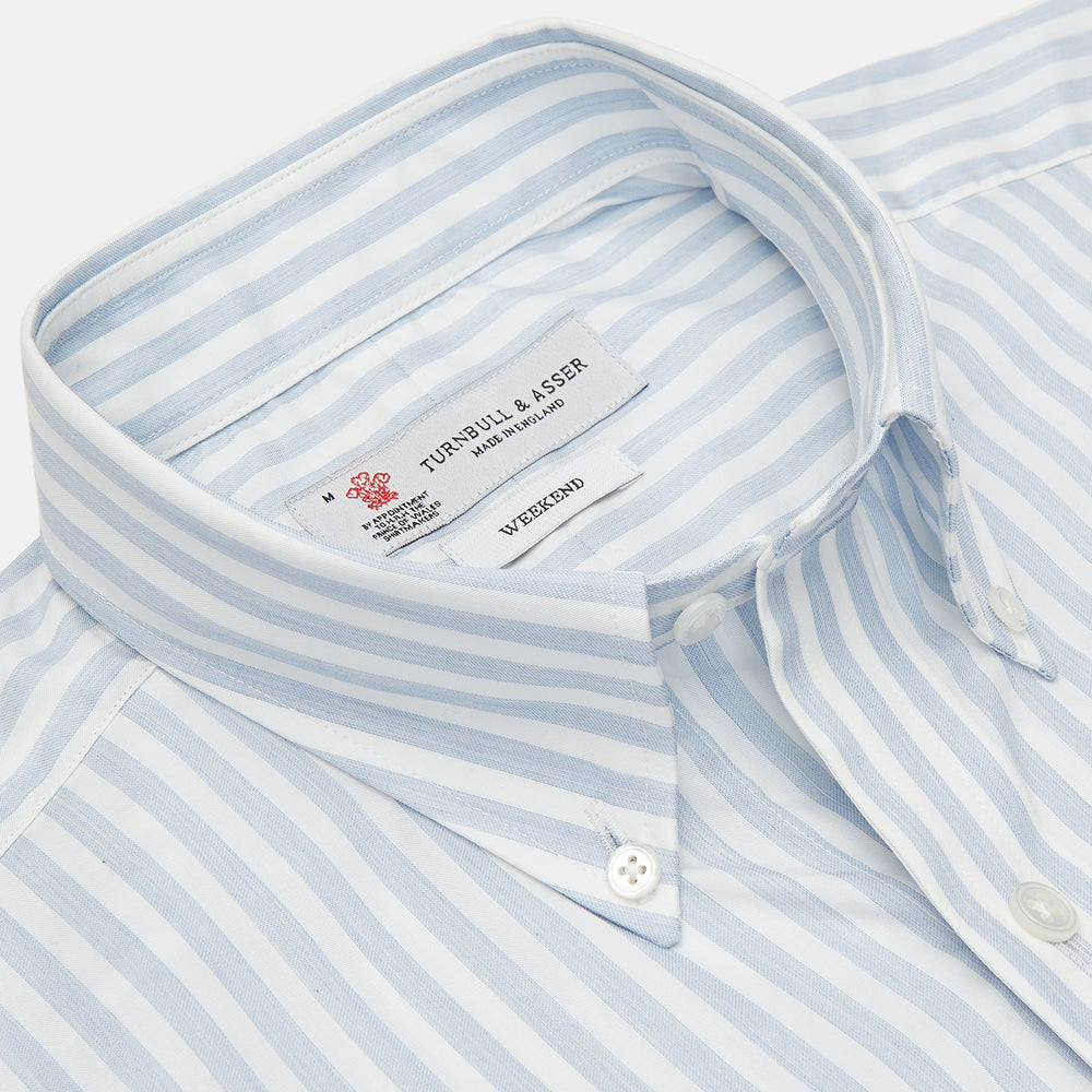 The Turnbull & Asser Weekend Fit Blue Stripe Cotton Shirt with Dorset collar and 1-button cuffs is laid flat on a white background, showcasing its classic long sleeves, striped design, and button-down front.