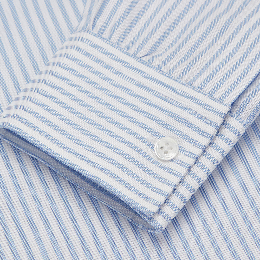 The Turnbull & Asser Blue and White Fine Stripe Oxford Weekend Fit Shirt features a Dorset collar and 1-button cuffs, shown laid flat on a white background. Part of our Weekend Fit shirts collection.