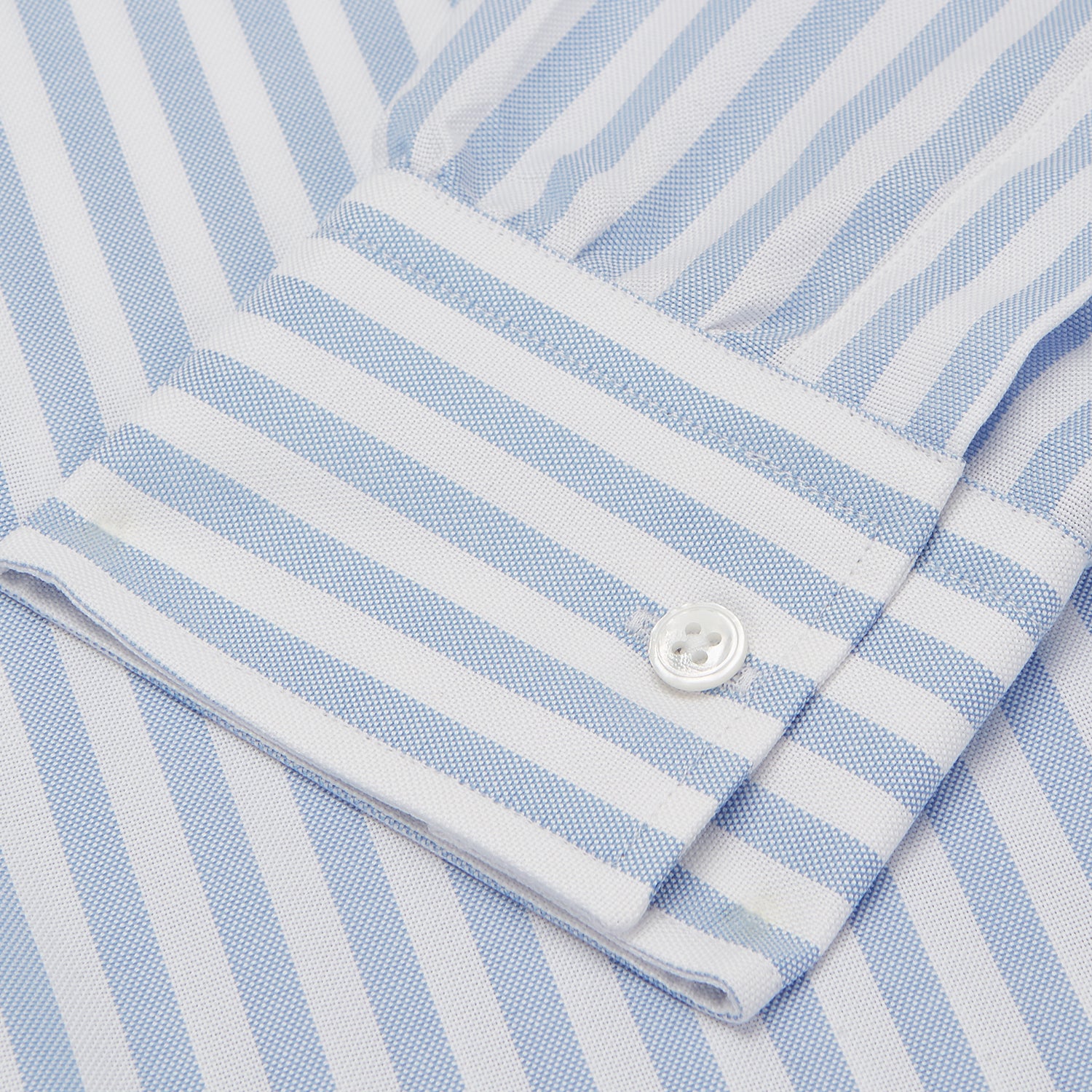 View 3 of product The Turnbull & Asser Blue and White Bengal Stripe Oxford Weekend Fit Shirt features a Dorset collar and 1-button cuffs, shown laid flat on a white background.