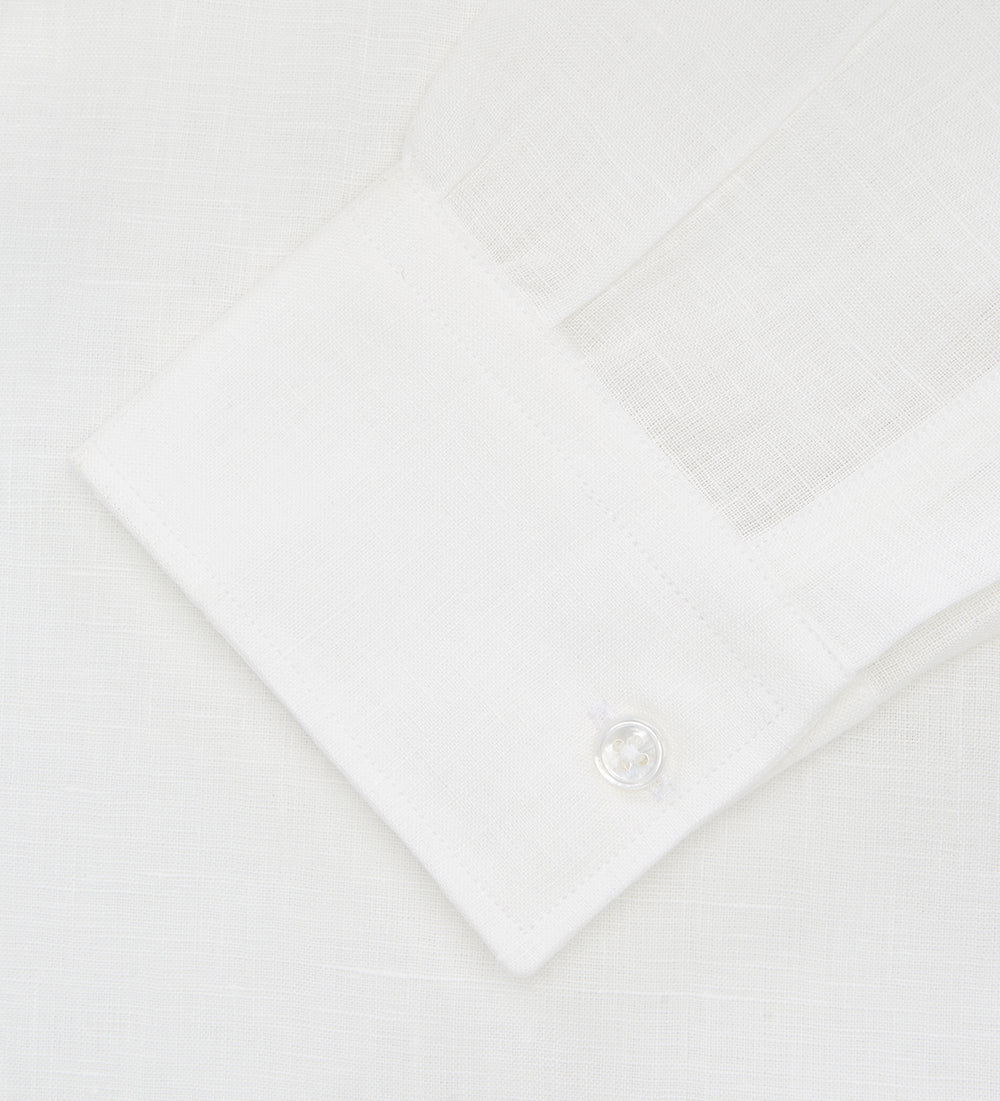 The Turnbull & Asser Cream Linen Weekend Fit Shirt features a Derby collar, 1-button cuffs, and single chest pocket, crafted from sustainable French linen. Shown laid flat on a white background.