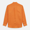 View 7 of product The Turnbull & Asser Orange Weekend Fit Linen Nevis Shirt features a Derby collar, long sleeves with 1-button cuffs, white buttons, and a chest pocket, shown flat against a white background.