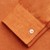View 5 of product The Turnbull & Asser Orange Weekend Fit Linen Nevis Shirt features a Derby collar, long sleeves with 1-button cuffs, white buttons, and a chest pocket, shown flat against a white background.