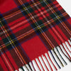 View 3 of product The Turnbull & Asser Royal Stewart Tartan Cashmere Scarf, showcasing a classic red plaid with black, yellow, and green accents and fringed ends, is displayed against a white background.