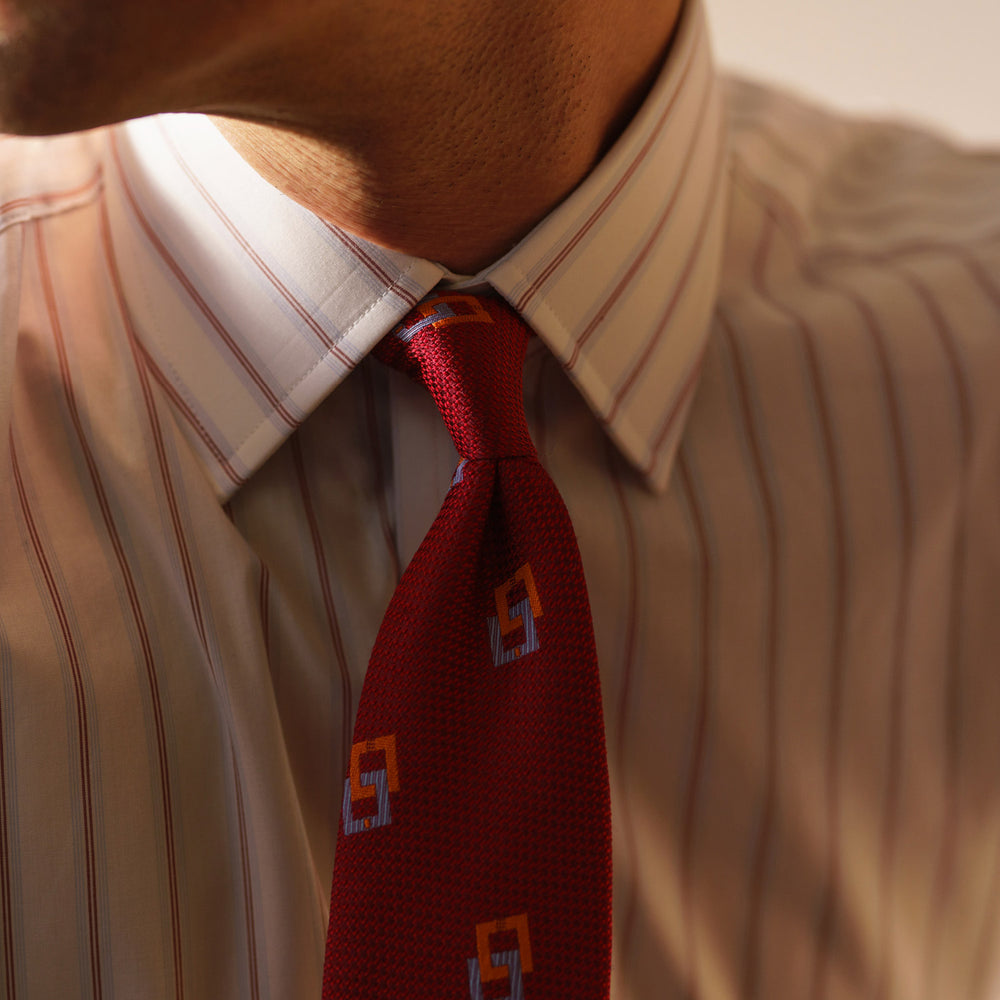The Turnbull & Asser Red and Blue Multi-stripe Cotton Regular Fit Mayfair Shirt features a button-down front and classic collar, displayed on a plain white background.