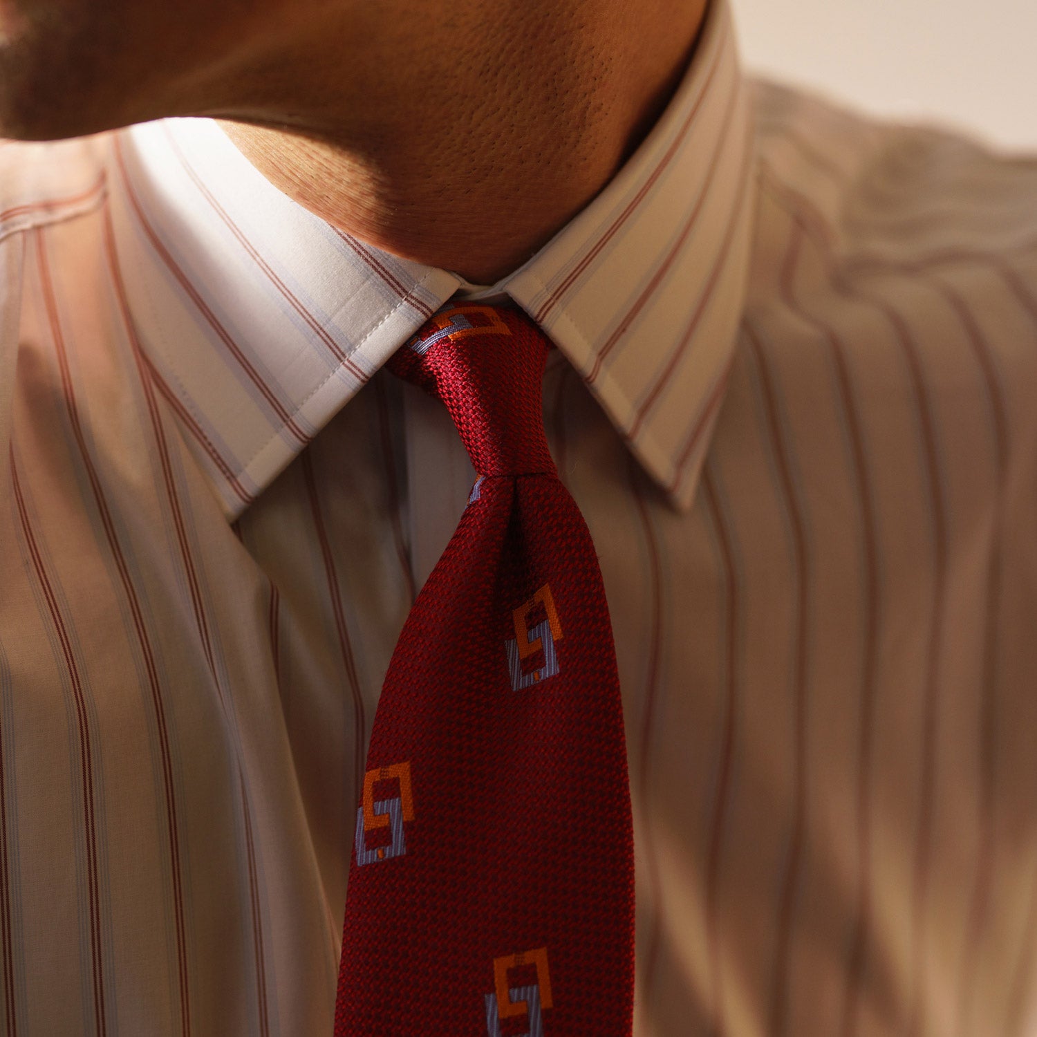 View 3 of product The Turnbull & Asser Red and Blue Multi-stripe Cotton Regular Fit Mayfair Shirt features a button-down front and classic collar, displayed on a plain white background.