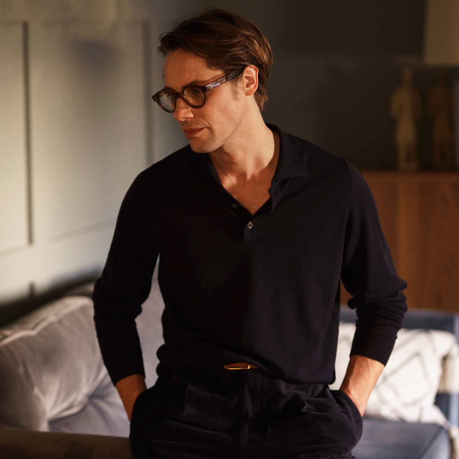 View 4 of product The Navy Merino Wool Cecil Rugby Polo Shirt by Turnbull & Asser features long sleeves, a collar, and a three-button placket—a timeless menswear staple laid flat on a white background.