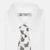 View 5 of product The Ecru Paisley Floral Cotton Silk Blend Tie by Turnbull & Asser features a paisley floral pattern, elegantly displayed and neatly rolled on a plain white background.