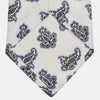 View 4 of product The Ecru Paisley Floral Cotton Silk Blend Tie by Turnbull & Asser features a paisley floral pattern, elegantly displayed and neatly rolled on a plain white background.
