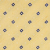View 2 of product The Turnbull & Asser Yellow Fine Square Slub Silk Tie features a soft yellow jacquard with a subtle texture, decorated with a repeating blue and white diamond pattern, shown rolled up on a plain white background.