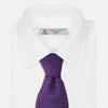 View 2 of product The Turnbull & Asser Purple Abstract Tonal Silk Jacquard Tie, featuring a textured geometric pattern, is shown rolled up against a white background—an ideal choice to elevate any formal outfit.