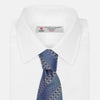 View 4 of product The Turnbull & Asser Dark Blue Baroque Stripe Silk Jacquard Tie, featuring elegant baroque stripes, is displayed rolled up on a white background.