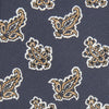 View 2 of product The Turnbull & Asser Navy Paisley Floral Cotton Silk Blend Tie features beige and light blue paisley motifs on navy, with one end rolled.