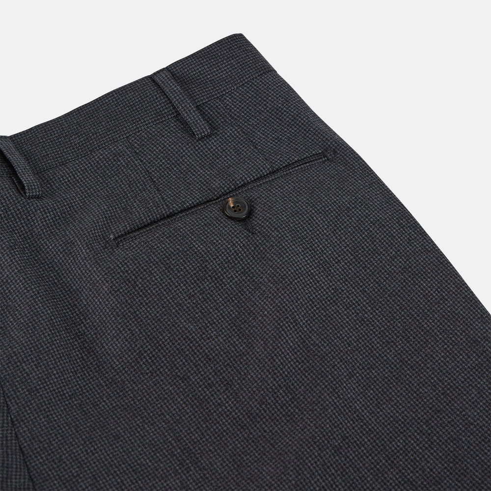 Turnbull & Asser Charcoal Houndstooth Flannel Trousers with a straight-leg cut, front zipper, button closure, belt loops, and side pockets, shown laid flat on a white background.