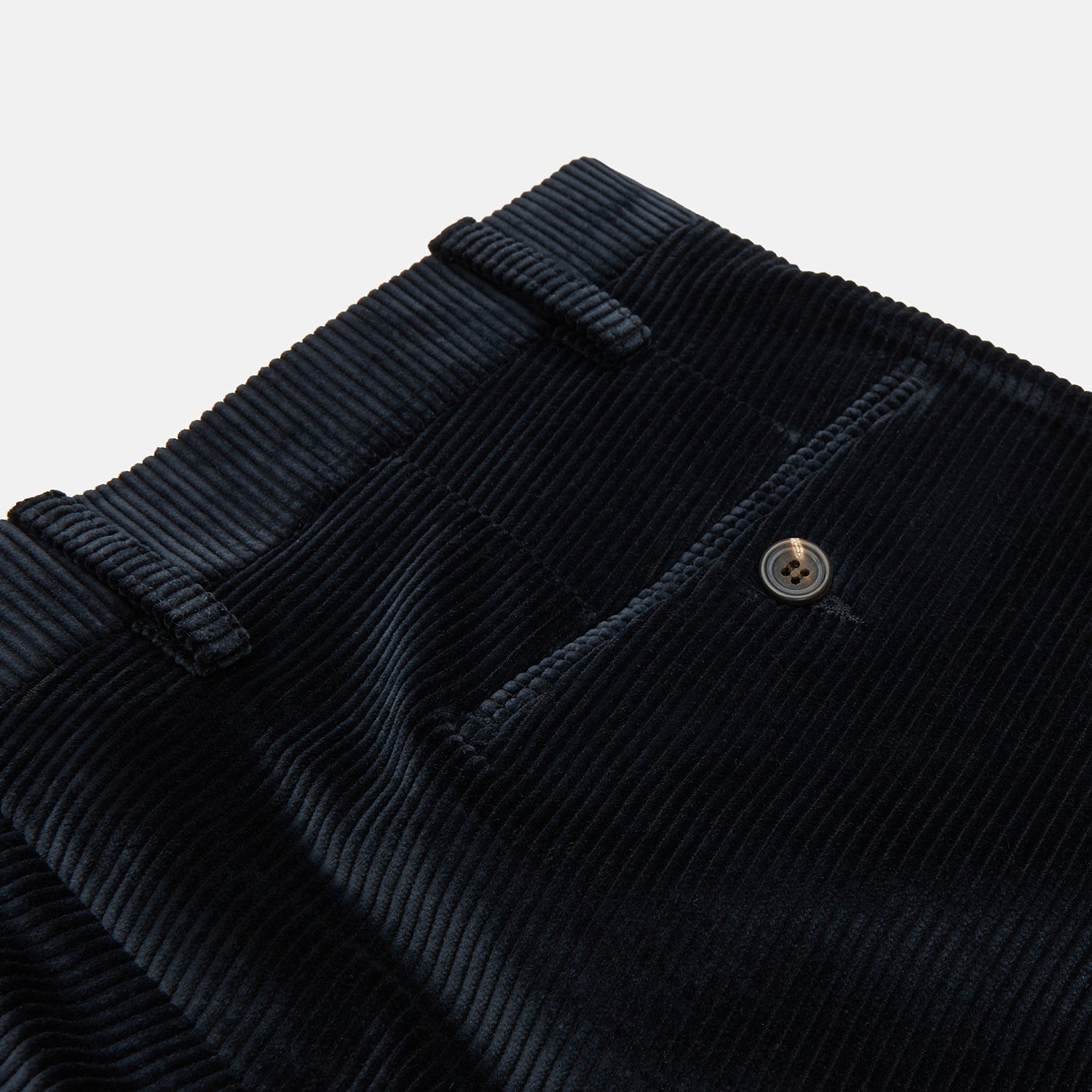 View 2 of product Turnbull & Asser Navy Horizontal Cord Trousers in pure cotton feature a straight-leg fit, side pockets, and button closure, shown against a plain light gray background.