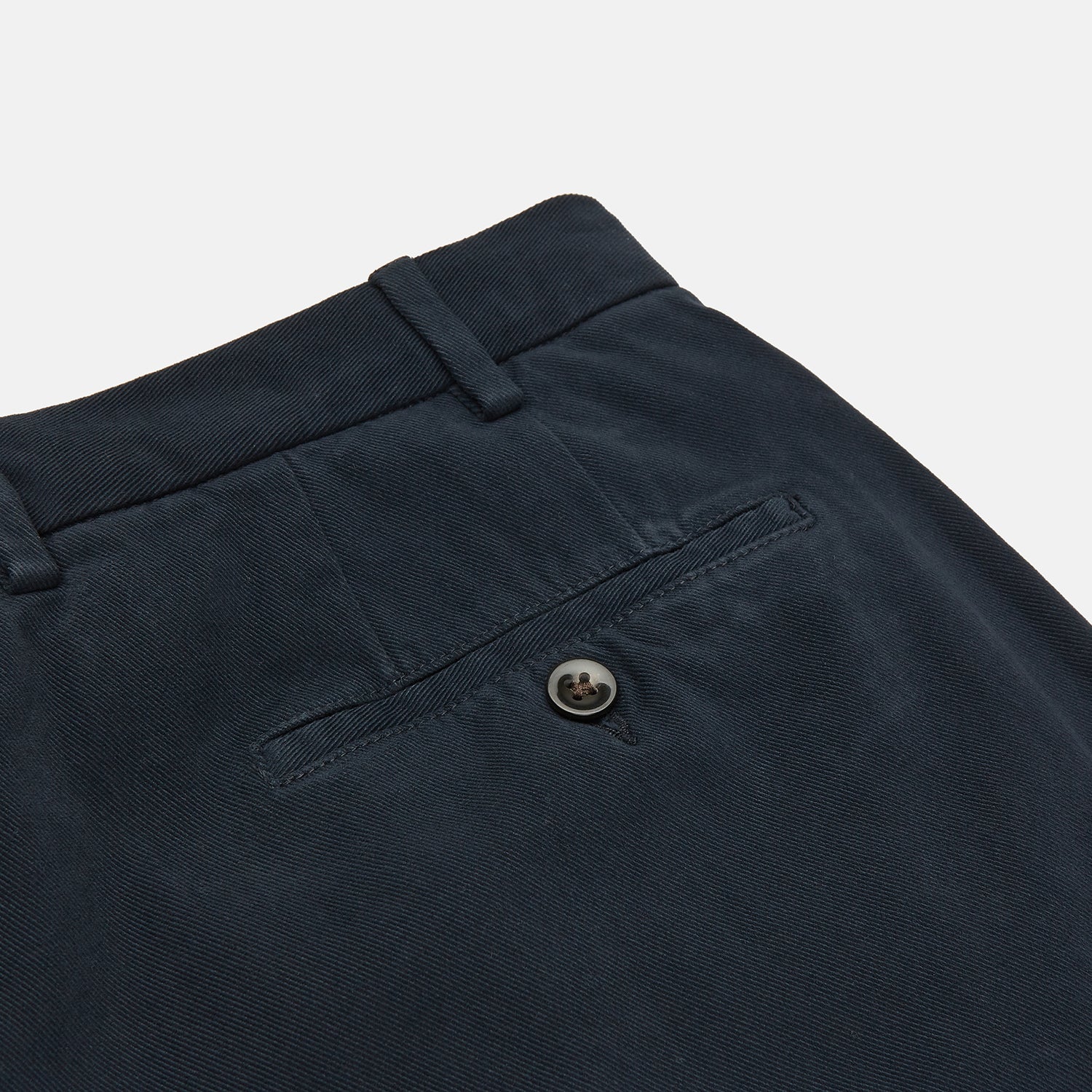View 2 of product Turnbull & Asser Navy Cotton Chinos—plain, straight-leg trousers with button closure and belt loops, tailored in Italy and featured against a white background.