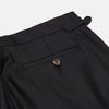 View 2 of product A pair of navy Escorial wool trousers by Turnbull & Asser, featuring a tailored style, straight-leg fit, front crease, belt loops, side pockets, and metal buckle details on the waistband, shown against a white background.