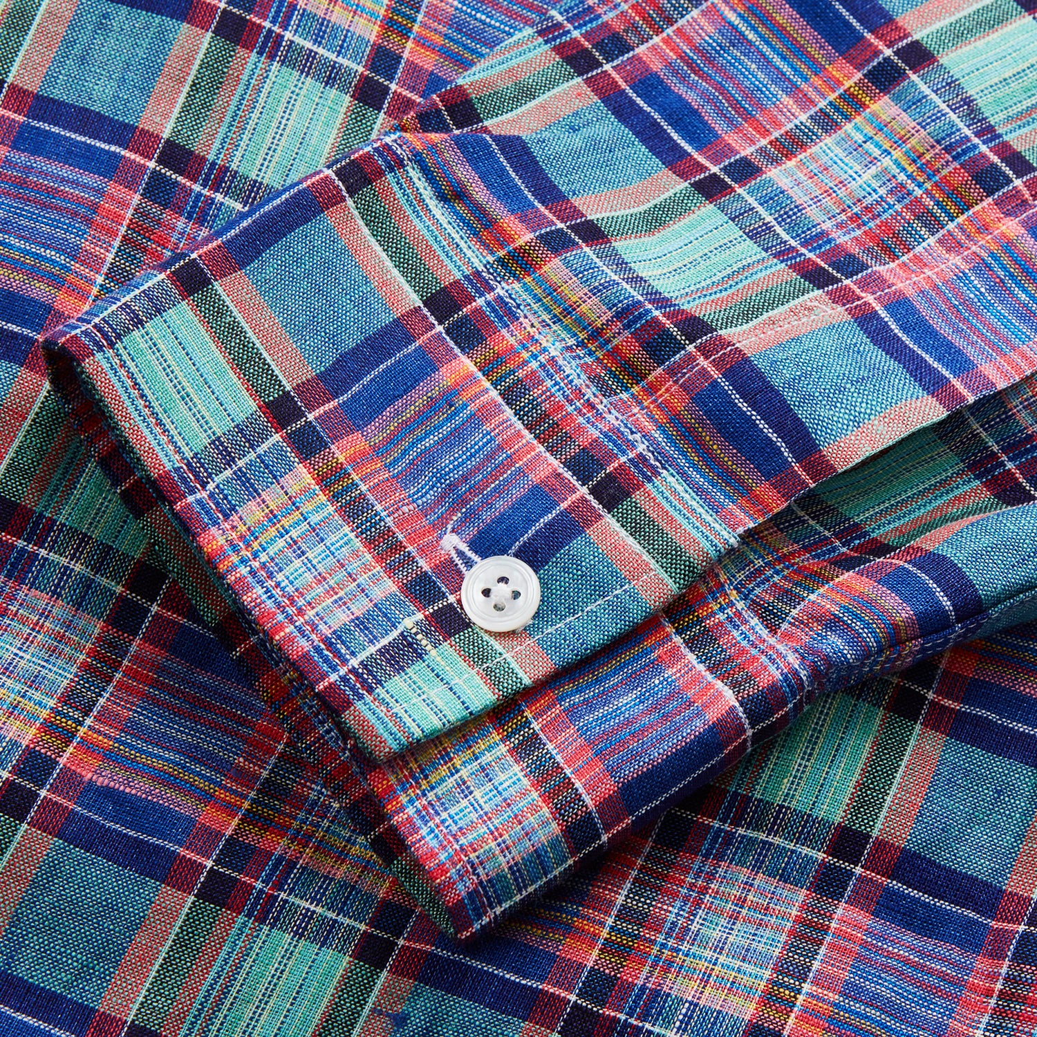 View 5 of product The Turnbull & Asser Green and Red Madras Check Weekend Fit Linen Shirt features a Derby collar, 1-button cuff, and colorful plaid pattern, crafted from sustainable linen and shown against a plain white background.