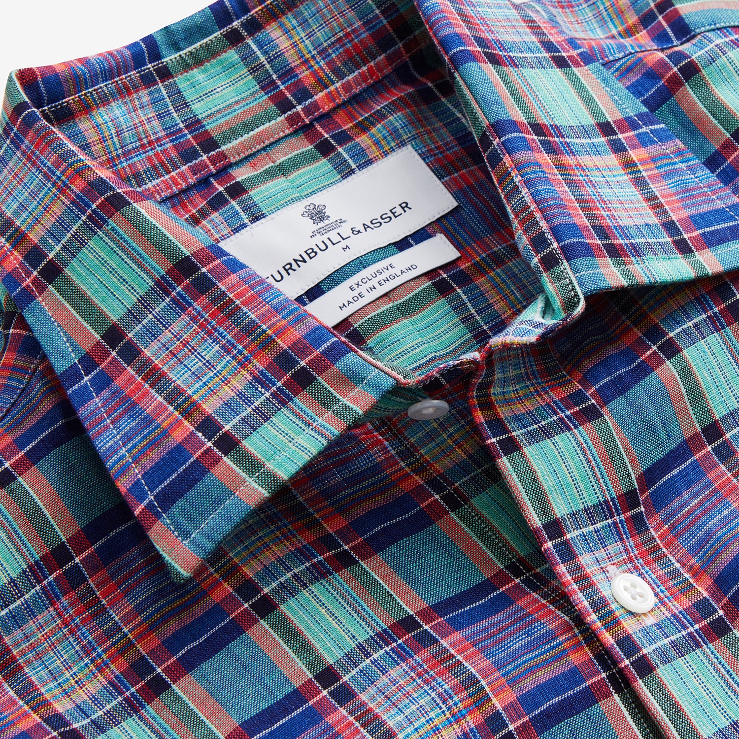 View 4 of product The Turnbull & Asser Green and Red Madras Check Weekend Fit Linen Shirt features a Derby collar, 1-button cuff, and colorful plaid pattern, crafted from sustainable linen and shown against a plain white background.
