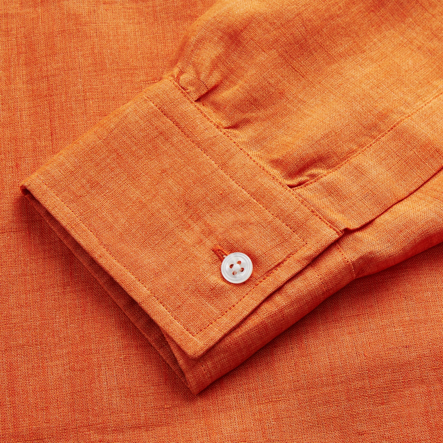 View 4 of product The Turnbull & Asser Orange Weekend Fit Long Sleeve Linen Shirt features a Derby collar, 1-button cuffs, white buttons, and a relaxed fit, shown against a white background.