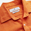 View 3 of product The Turnbull & Asser Orange Weekend Fit Long Sleeve Linen Shirt features a Derby collar, 1-button cuffs, white buttons, and a relaxed fit, shown against a white background.