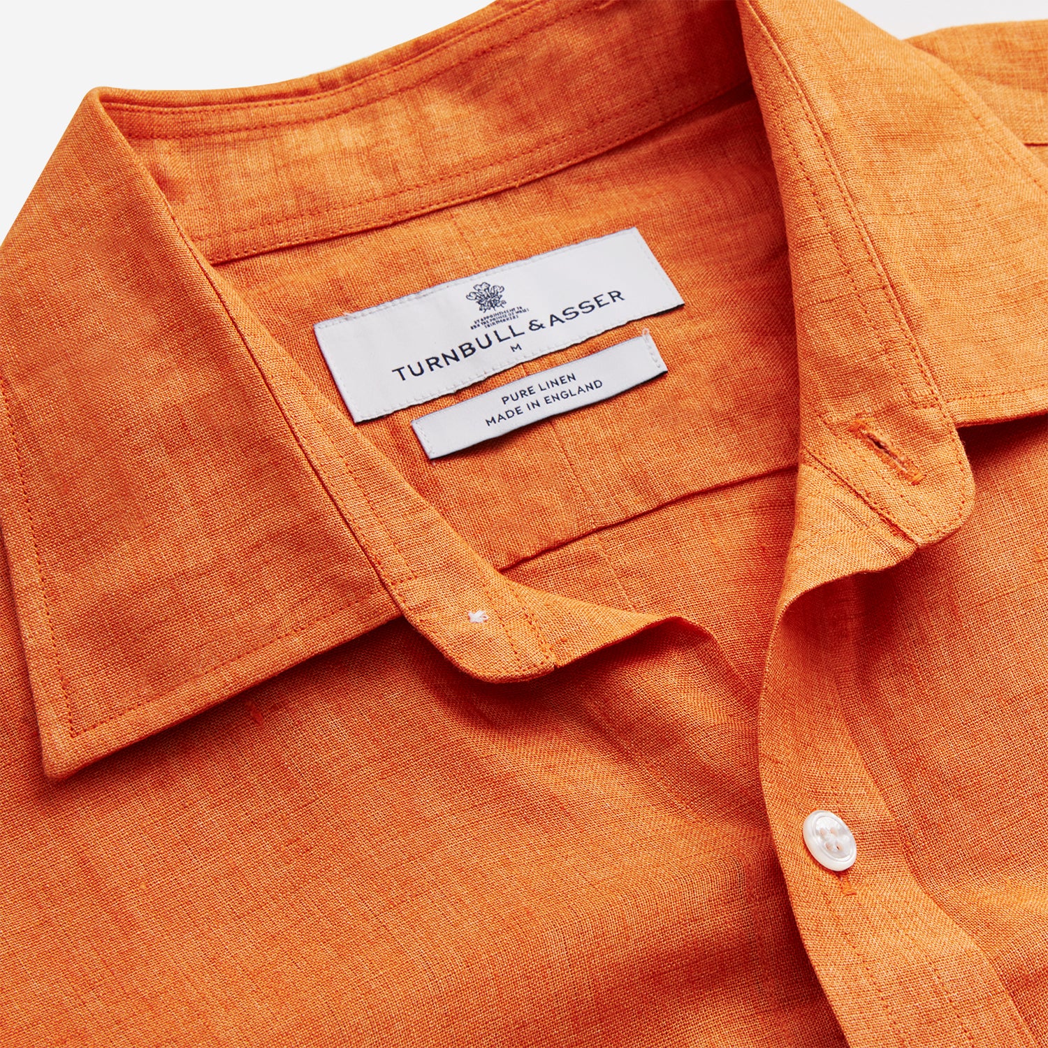 View 3 of product The Turnbull & Asser Orange Weekend Fit Long Sleeve Linen Shirt features a Derby collar, 1-button cuffs, white buttons, and a relaxed fit, shown against a white background.