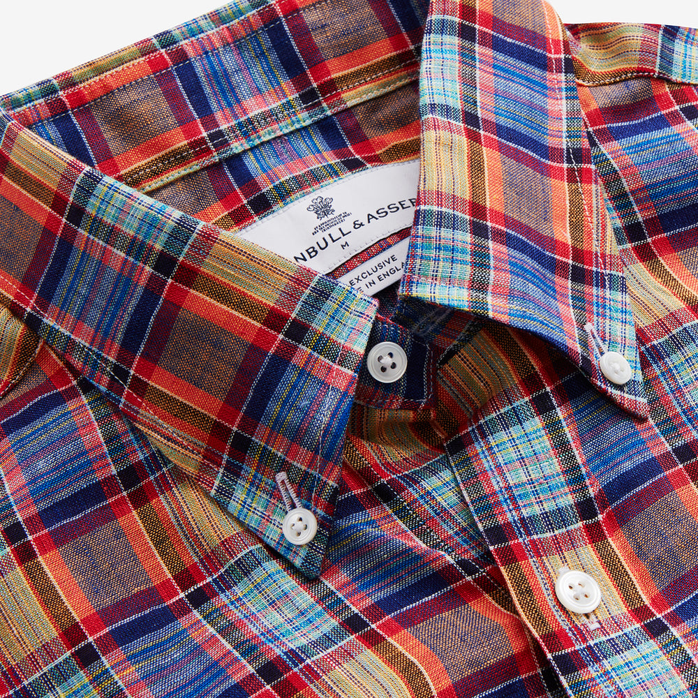 The Turnbull & Asser Blue and Orange Madras Check Weekend Fit Short Sleeve Linen Shirt features a colorful plaid pattern and a Dorset collar, shown against a plain white background.