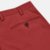 View 2 of product Turnbull & Asser Clay Red Cotton Twill Pleated Trousers feature a tailored fit, side pockets, and front button closure. Made in Italy, they're ideal for smart casual looks and are showcased against a plain white background.