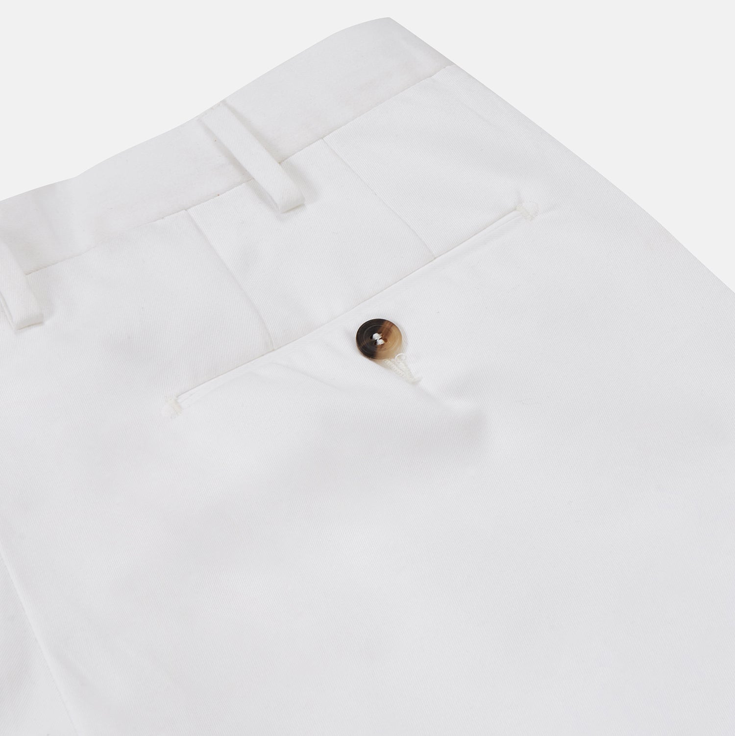 View 4 of product Turnbull & Asser’s White Cotton Pleated Trousers, a summer classic, are elegantly displayed against a crisp white backdrop.