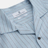 View 4 of product Turnbull & Asser's Pale Blue Stripe Cotton Holiday Fit Shirt features a revere collar, thin black pinstripes, single button cuff, chest pocket, and black buttons—crafted from Italian cotton and laid flat on a white background.