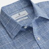 View 3 of product The Indigo Linen Glen Check Weekend Fit Shirt with Derby Collar by Turnbull & Asser is a light blue, long-sleeve checked linen shirt, featuring a subtle white plaid pattern and shown against a plain white background.