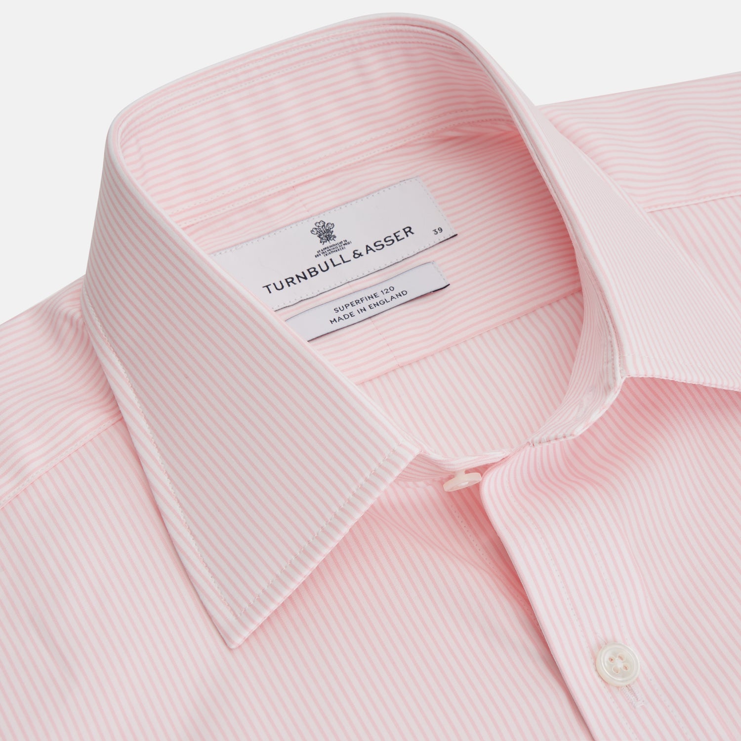 View 3 of product The Pink Fine Stripe Regular Fit Shirt with T&A Collar by Turnbull & Asser is a light pink, long-sleeve poplin shirt made from Italian cotton, featuring white buttons and shown flat on a white background.