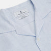 View 2 of product The Turnbull & Asser Blue Linen Stripe Holiday Fit Shirt features short sleeves, a revere collar, and single chest pocket, perfect for resort wear. Shown on a plain white background.