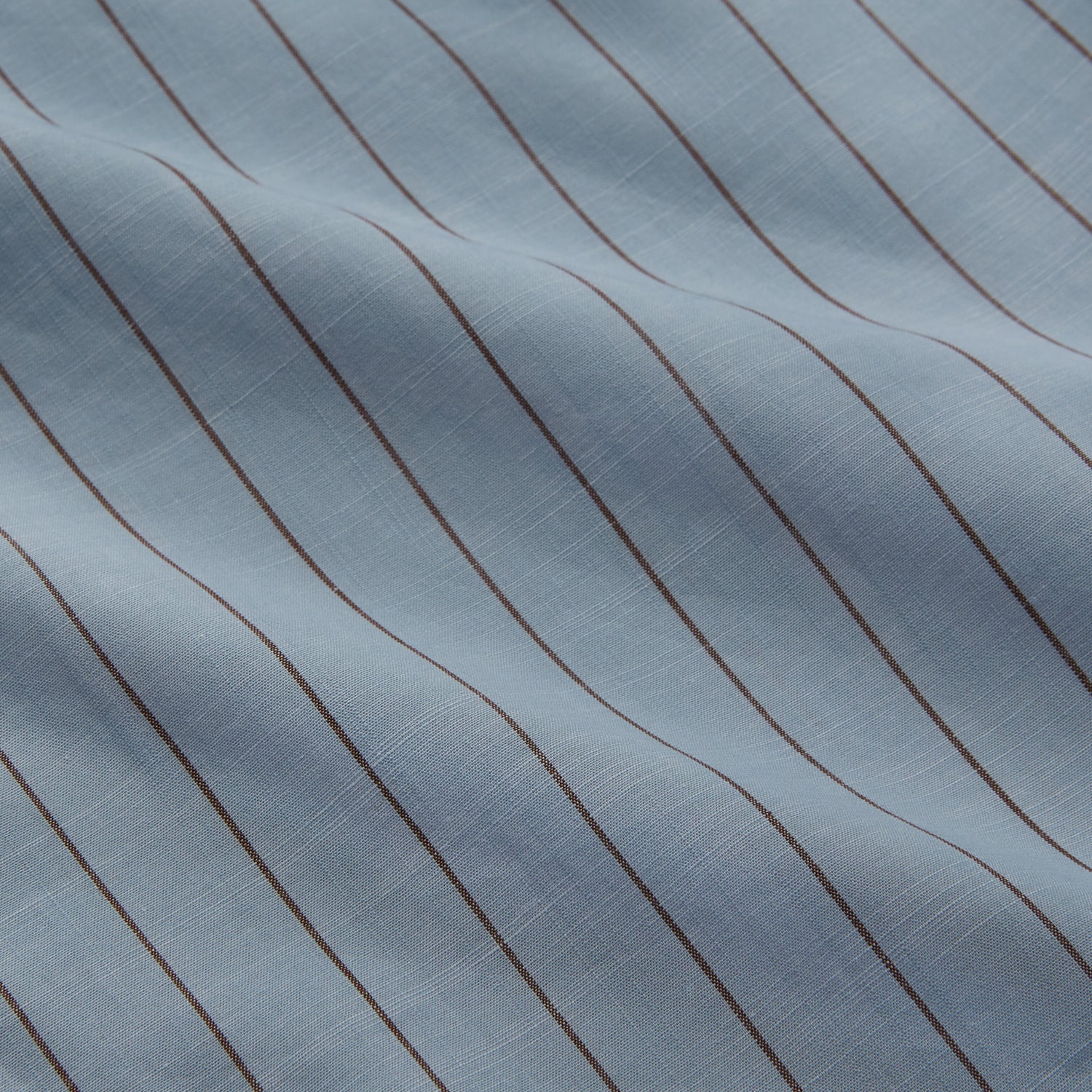View 2 of product Turnbull & Asser's Pale Blue Stripe Cotton Holiday Fit Shirt features a revere collar, thin black pinstripes, single button cuff, chest pocket, and black buttons—crafted from Italian cotton and laid flat on a white background.