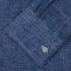 View 4 of product The Indigo Linen Weekend Fit Shirt with Derby Collar by Turnbull & Asser, shown flat on a white background, features long sleeves, white buttons, and buttoned cuffs—ideal for pairing with a classic suit or for casual wear.