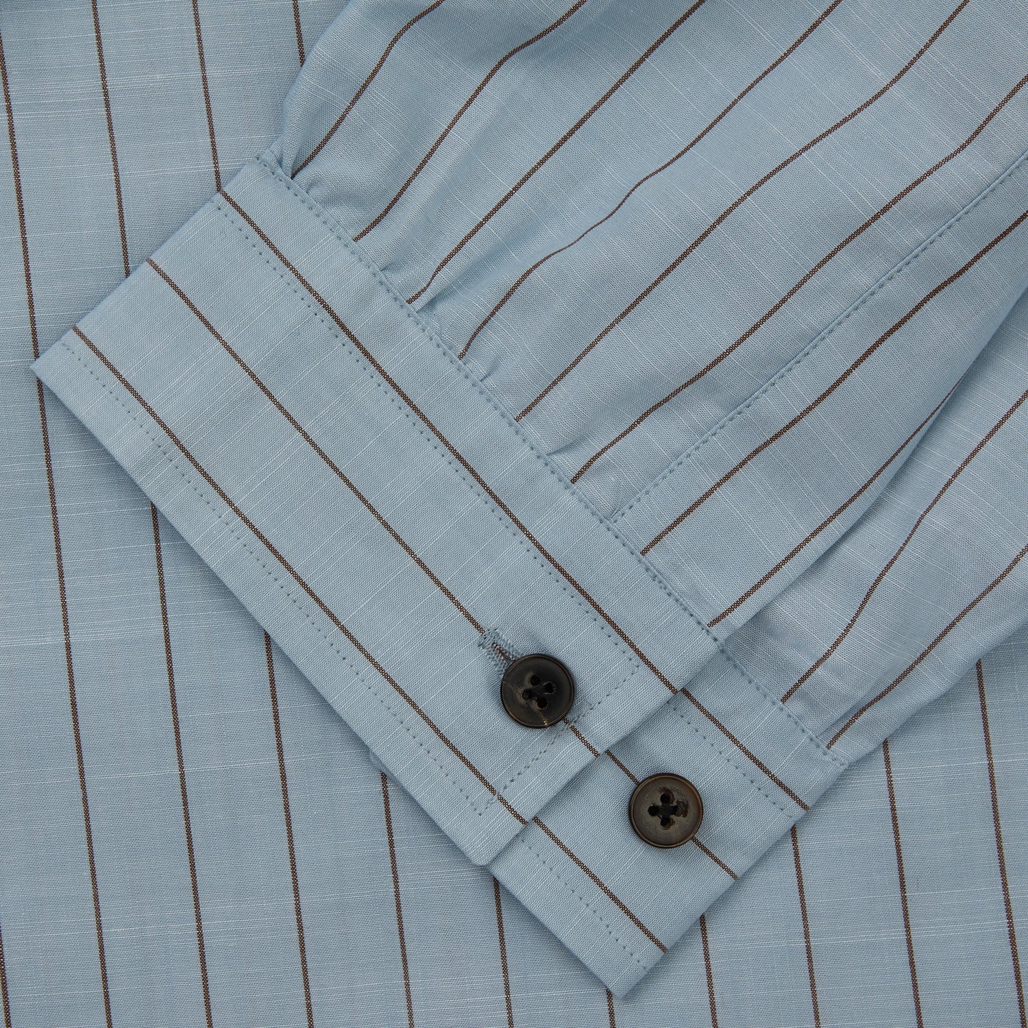 View 3 of product Turnbull & Asser's Pale Blue Stripe Cotton Holiday Fit Shirt features a revere collar, thin black pinstripes, single button cuff, chest pocket, and black buttons—crafted from Italian cotton and laid flat on a white background.