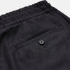 View 3 of product Turnbull & Asser Charcoal Tailored Drawstring Trousers in wool flannel, featuring an elastic waistband, straight legs, and side pockets, shown laid flat on a white background.