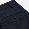 View 2 of product The Navy Wool Pleated Jasper Trouser by Turnbull & Asser features lightweight wool, a button and zipper closure, front pockets, and straight legs, shown neatly pressed against a plain white background.