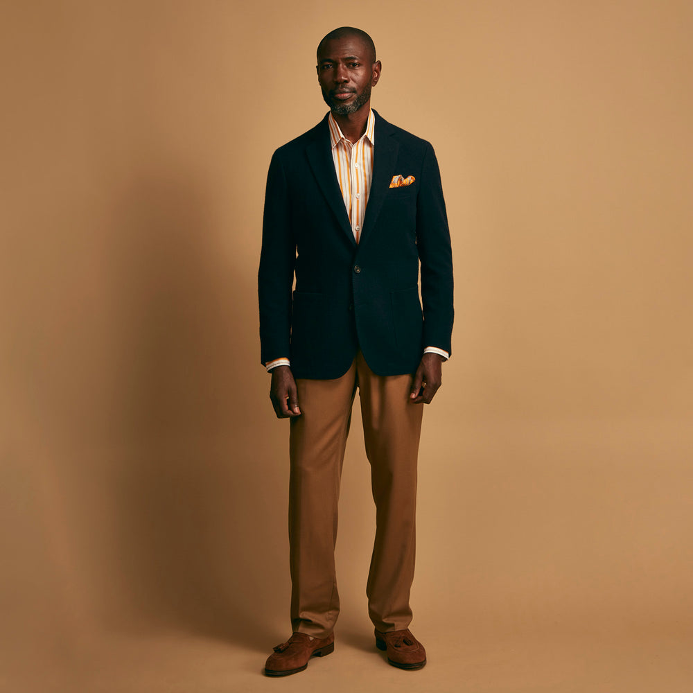 The Turnbull & Asser Navy Cashmere Bern Blazer features a notched lapel, two-button front, three front pockets, and cuff button details. Shown laid flat on a white background.