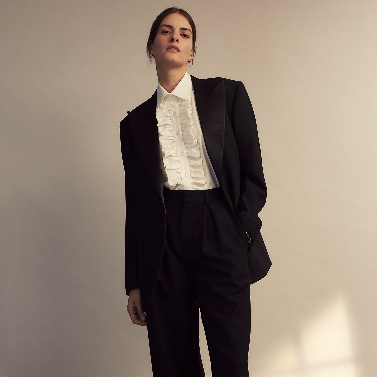 View 8 of product The Turnbull & Asser Turnbull and The Deck Cream Silk Romantic Shirt features long sleeves, a pointed collar, and elegant front ruffles, shown against a plain light gray background.