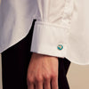View 2 of product Turnbull & Asser’s Teal Magnolia Hand-painted Cufflinks feature circular sterling silver faces with magnolia designs on a teal background. Each handmade pair is shown on a plain white surface.