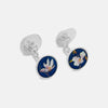 View 2 of product A close-up of a white shirt cuff adorned with Turnbull & Asser’s Royal Blue Magnolia Hand-painted Cufflink, featuring a blue background and white flower design with yellow and brown accents.