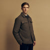 View 4 of product The Green Quilted Cashmere Amhurst Overshirt by Turnbull & Asser features a collar, long sleeves, button-flap chest pockets, and thermo-regulating graphene wadding. Displayed on a plain white background.