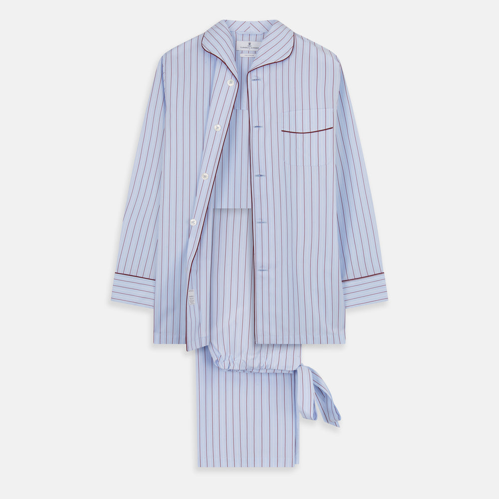 The Turnbull & Asser Burgundy Stripe Classic Pyjama Set features long sleeves, a button-up top with red piping, matching drawstring pants, and a traditional fit. Laid flat, it's luxury loungewear in signature burgundy stripes.